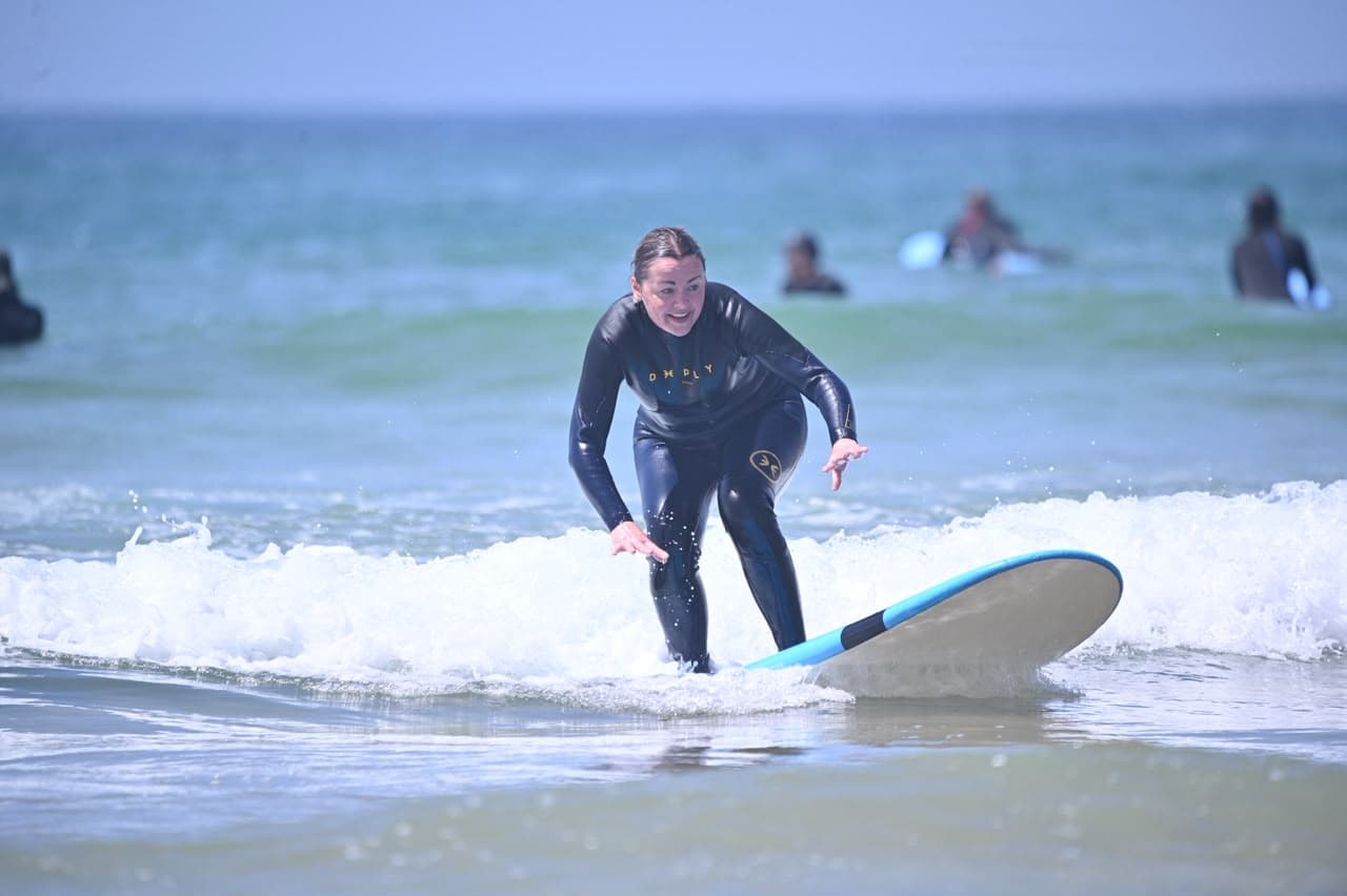 A surfer riding a small clean wave